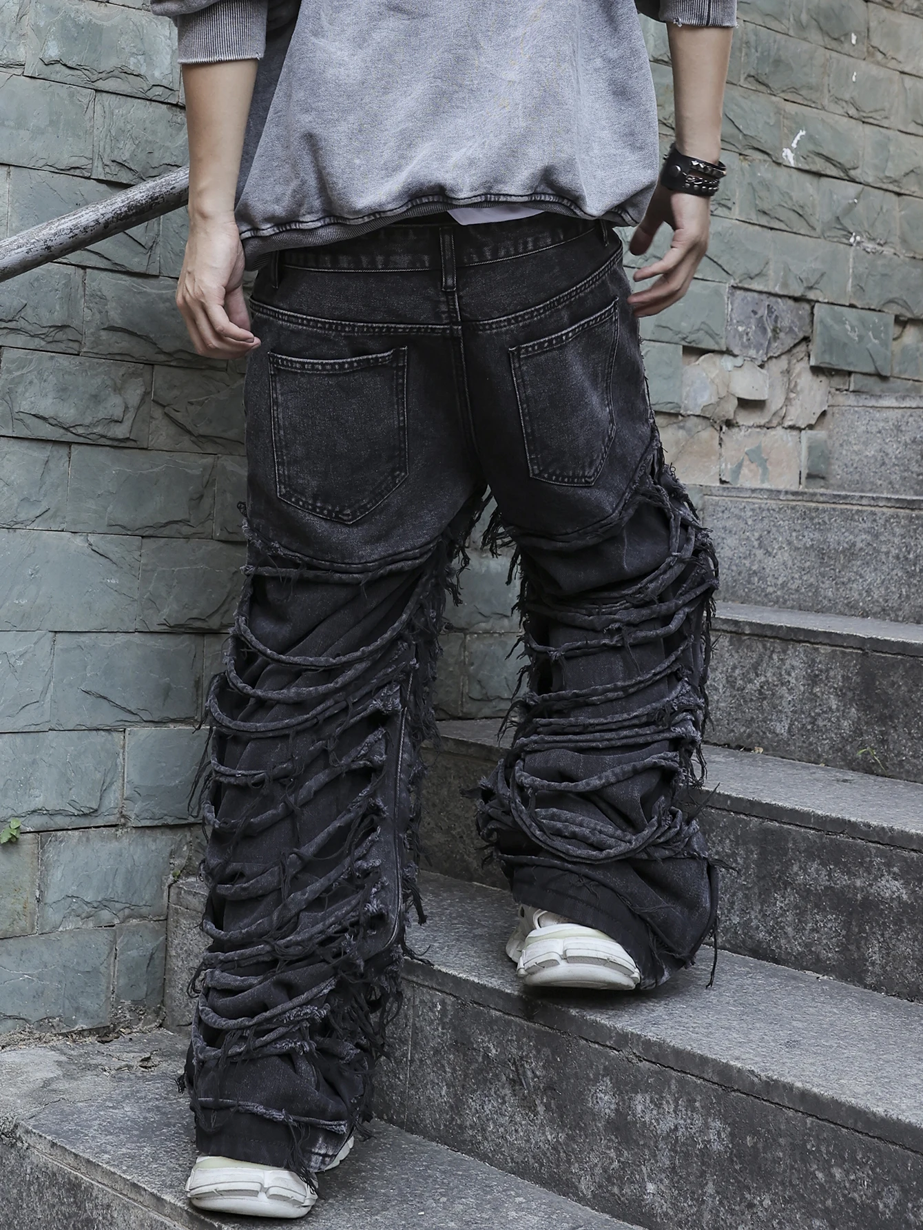 Men's black jeans. With a design of (ripped holes) and tassels. In a street trend style. - Image 2